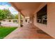 Covered patio featuring a stone floor and a view of the landscaped backyard at 4010 N 156Th Ln, Goodyear, AZ 85395