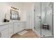 Bright bathroom with double sink vanity, custom white cabinets, and a frameless glass shower at 4010 N 156Th Ln, Goodyear, AZ 85395