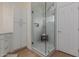 Bright bathroom featuring a spacious walk-in shower and custom white storage cabinets at 4010 N 156Th Ln, Goodyear, AZ 85395