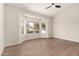Sunlit bedroom with hardwood floors and bay window at 4010 N 156Th Ln, Goodyear, AZ 85395
