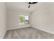 Bedroom with neutral carpet, ceiling fan and bright window with street view at 4010 N 156Th Ln, Goodyear, AZ 85395