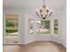 Open dining area featuring wood floors and large windows overlooking the pool at 4010 N 156Th Ln, Goodyear, AZ 85395