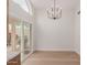 Bright dining room featuring wood floors, modern chandelier, and sliding glass doors at 4010 N 156Th Ln, Goodyear, AZ 85395