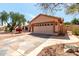 Attractive home featuring a patterned driveway, desert landscaping and a two-car garage at 4010 N 156Th Ln, Goodyear, AZ 85395
