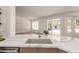 Modern kitchen with an undermount sink with a view to the backyard and stainless steel appliances at 4010 N 156Th Ln, Goodyear, AZ 85395