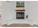 Cozy living room with a decorative fireplace, wooden mantle and built-in seating at 4010 N 156Th Ln, Goodyear, AZ 85395