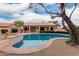A stunning view of the backyard pool and charming home showcasing a well-maintained outdoor space at 4010 N 156Th Ln, Goodyear, AZ 85395