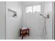Walk-in shower featuring a mosaic tile floor, bench seating, rain shower head and custom shelving at 4010 N 156Th Ln, Goodyear, AZ 85395