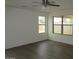 Inviting bedroom with ample natural light streaming through two large windows and hardwood floors at 41246 N Vine Ave, San Tan Valley, AZ 85140