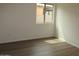 Inviting bedroom with ample natural light streaming through window and hardwood floors at 41246 N Vine Ave, San Tan Valley, AZ 85140