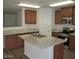 Well-lit kitchen with granite countertops, wood cabinets, and stainless steel appliances at 41246 N Vine Ave, San Tan Valley, AZ 85140