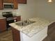 Kitchen island with a stainless steel sink, granite countertop, and stainless steel appliances at 41246 N Vine Ave, San Tan Valley, AZ 85140