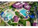 Aerial view of community pool, slides, and a sand volleyball court and community center at 4433 W Phalen Dr, Phoenix, AZ 85087