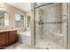 Bathroom featuring tiled shower with glass door, vanity, and bathtub with tile surround and corner window at 4433 W Phalen Dr, Phoenix, AZ 85087