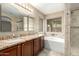 Bright bathroom featuring double vanities, large soaking tub, and windows for natural light and ventilation at 4433 W Phalen Dr, Phoenix, AZ 85087