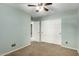 Bedroom with a ceiling fan, a closet, and carpeted floors offering a welcoming atmosphere at 4433 W Phalen Dr, Phoenix, AZ 85087