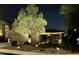 Night exterior view of home featuring desert landscaping, accent lighting, and a two car garage at 4433 W Phalen Dr, Phoenix, AZ 85087