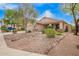 Inviting single-story home featuring desert landscaping, rock features, and a covered porch at 4433 W Phalen Dr, Phoenix, AZ 85087