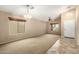 Spacious living room with carpet and tile flooring, neutral walls, and ample natural light at 4433 W Phalen Dr, Phoenix, AZ 85087