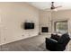 Spacious living room with plush carpet, a fireplace, and a sliding door to outdoor living spaces at 4433 W Phalen Dr, Phoenix, AZ 85087
