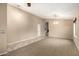 Open-concept living room featuring neutral carpet, tile flooring, and bright lighting fixtures at 4433 W Phalen Dr, Phoenix, AZ 85087