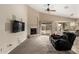 Cozy living room featuring plush carpet, a fireplace, and a sliding door to the outdoor living spaces at 4433 W Phalen Dr, Phoenix, AZ 85087