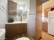 Bathroom featuring wood cabinets, a sink, a mirror, and a view into the kitchen at 457 S Jaspar Dr, Apache Junction, AZ 85119