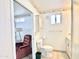 Bathroom with a vanity, commode, tile floors, and adjoining living room at 457 S Jaspar Dr, Apache Junction, AZ 85119