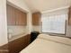 Bedroom with built-in cabinets and drawers on the side and natural light from a window at 457 S Jaspar Dr, Apache Junction, AZ 85119