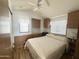 Bedroom with built-in drawers, cabinets, ceiling fan, and natural light from two windows at 457 S Jaspar Dr, Apache Junction, AZ 85119