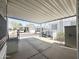 Covered carport with ample parking space and views of neighboring manufactured homes in a quiet community at 457 S Jaspar Dr, Apache Junction, AZ 85119