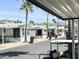 Scenic view of a manufactured home community with palm trees and mountain views in the distance at 457 S Jaspar Dr, Apache Junction, AZ 85119