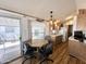 Bright dining area featuring wood-look floors, a table with seating, and natural light at 457 S Jaspar Dr, Apache Junction, AZ 85119
