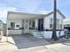 Charming manufactured home featuring a covered carport and well-maintained landscaping at 457 S Jaspar Dr, Apache Junction, AZ 85119