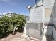 Exterior view of the property, with a well-maintained air conditioning unit and mature orange tree at 457 S Jaspar Dr, Apache Junction, AZ 85119