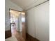 Hallway leading to the kitchen with white appliances, a dining area, and office space at 457 S Jaspar Dr, Apache Junction, AZ 85119