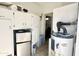 Bright laundry area includes white cabinets, a mini refrigerator, and a newer water heater at 457 S Jaspar Dr, Apache Junction, AZ 85119