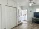 Living room area with bi-fold closet doors and entry door at 457 S Jaspar Dr, Apache Junction, AZ 85119