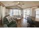 Well-lit living room with comfortable seating, neutral decor, and wood-look flooring at 457 S Jaspar Dr, Apache Junction, AZ 85119
