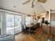 Open-concept living room and dining area with wood-look flooring and access to the patio at 457 S Jaspar Dr, Apache Junction, AZ 85119