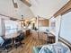 Bright living room featuring wood-look floors, comfortable seating, and a dining area at 457 S Jaspar Dr, Apache Junction, AZ 85119