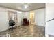 View of the living room with tile flooring, a ceiling fan, accent chair, and doorway to bathroom at 457 S Jaspar Dr, Apache Junction, AZ 85119