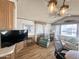 Cozy living room with wood-look flooring, a ceiling fan, and natural light from large windows at 457 S Jaspar Dr, Apache Junction, AZ 85119