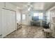 Bright living room featuring tile flooring, ceiling fan, a window for natural light, and entry door at 457 S Jaspar Dr, Apache Junction, AZ 85119