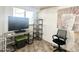 Living room with natural light from the window, desk with TV, tile flooring, and decor at 457 S Jaspar Dr, Apache Junction, AZ 85119