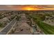Aerial view of a residential community with pools and neighborhood parks at sunset at 4630 E Hazeltine Way, Chandler, AZ 85249