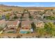 Aerial view of homes with pools in a desert community with mountain views in the background at 4630 E Hazeltine Way, Chandler, AZ 85249