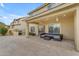 Backyard featuring a covered patio with outdoor seating, a built-in grill area, and a well-manicured lawn at 4630 E Hazeltine Way, Chandler, AZ 85249