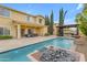 Backyard with a gorgeous pool, lush landscaping, water feature, and covered patio, blending luxury with outdoor living at 4630 E Hazeltine Way, Chandler, AZ 85249