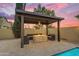 A covered outdoor seating area featuring a cozy fire pit, perfect for relaxing evenings at 4630 E Hazeltine Way, Chandler, AZ 85249